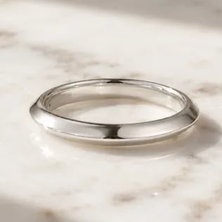 simple womens wedding ring on marble table