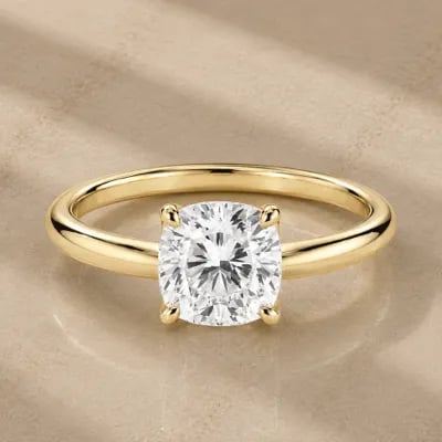 cushion cut solitaire engagement ring on neutral background