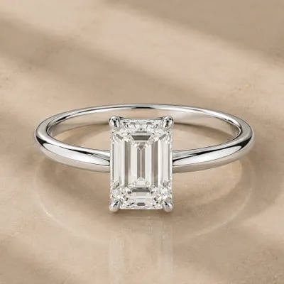 emerald cut solitaire engagement ring on neutral background