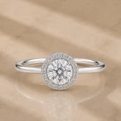 halo engagement ring on neutral background