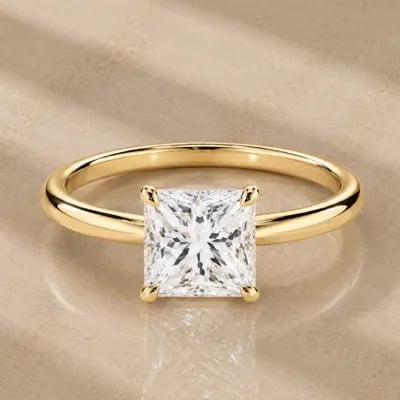 princess cut solitaire engagement ring on neutral background