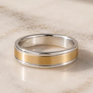 mens two tone wedding band on marble table
