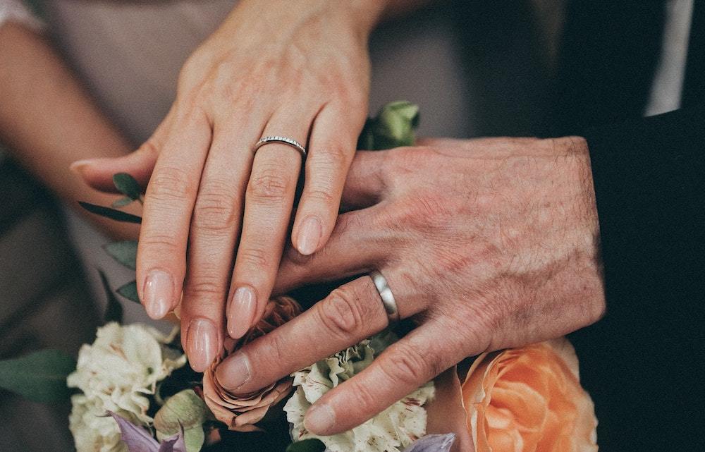 couple wearing wedding rings